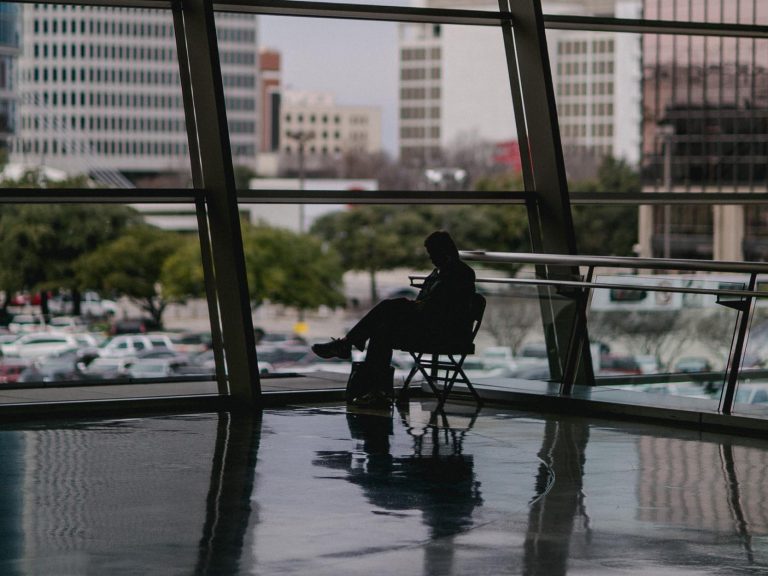Silhouetted Man Sitting in Building